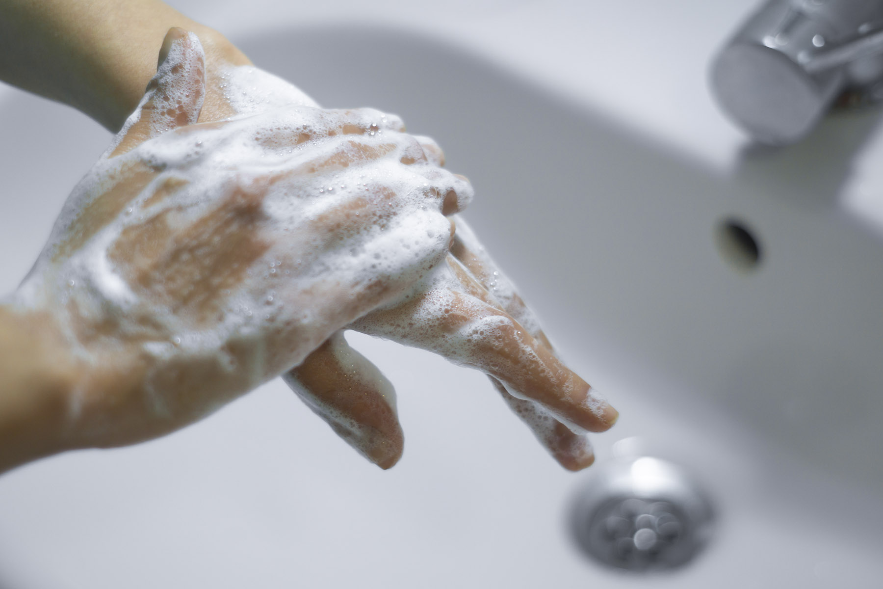 Demonstrating proper hand hygiene.